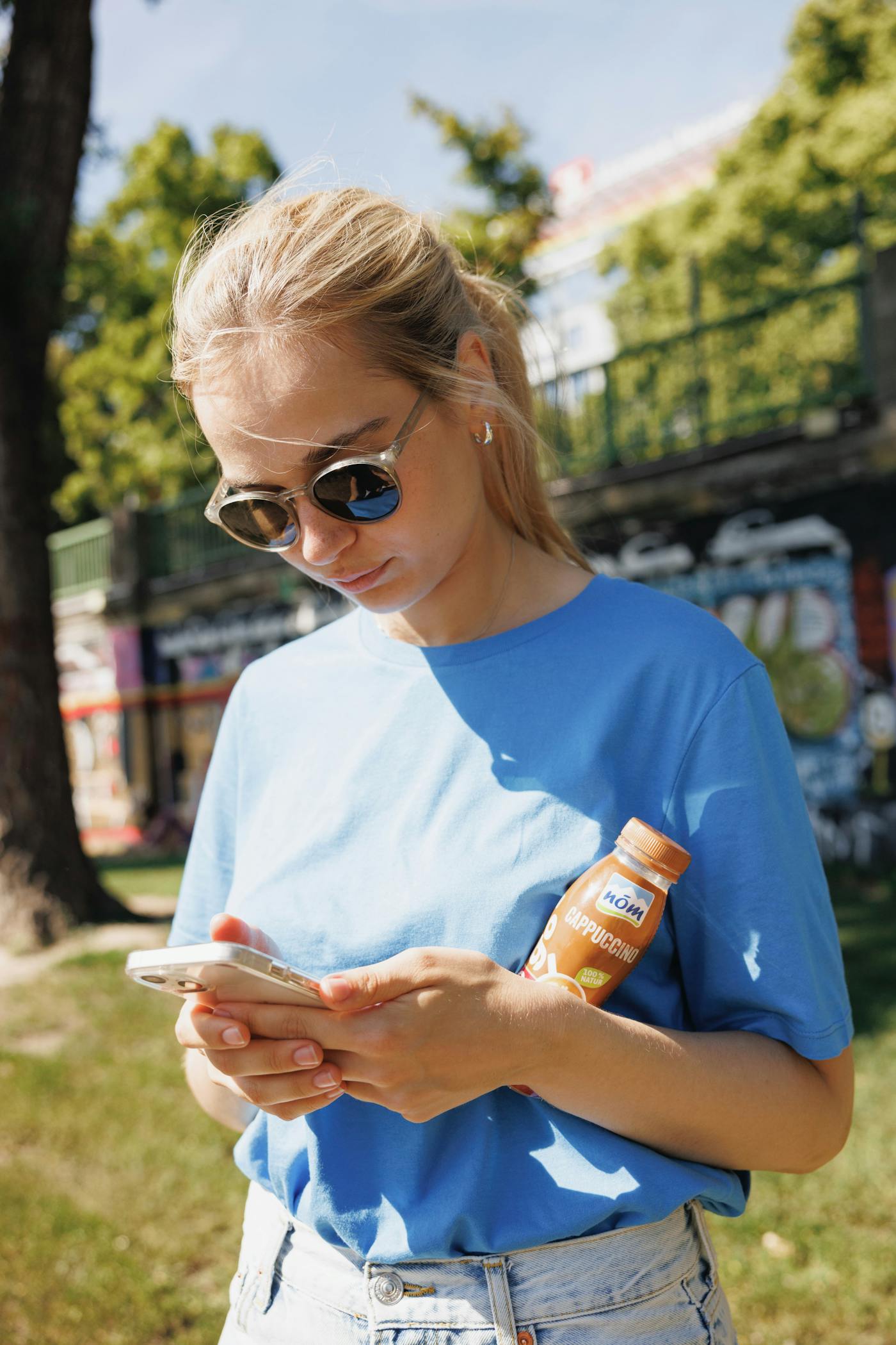 Ein Mädchen mit blauem Shirt spielt auf ihrem Smartphone